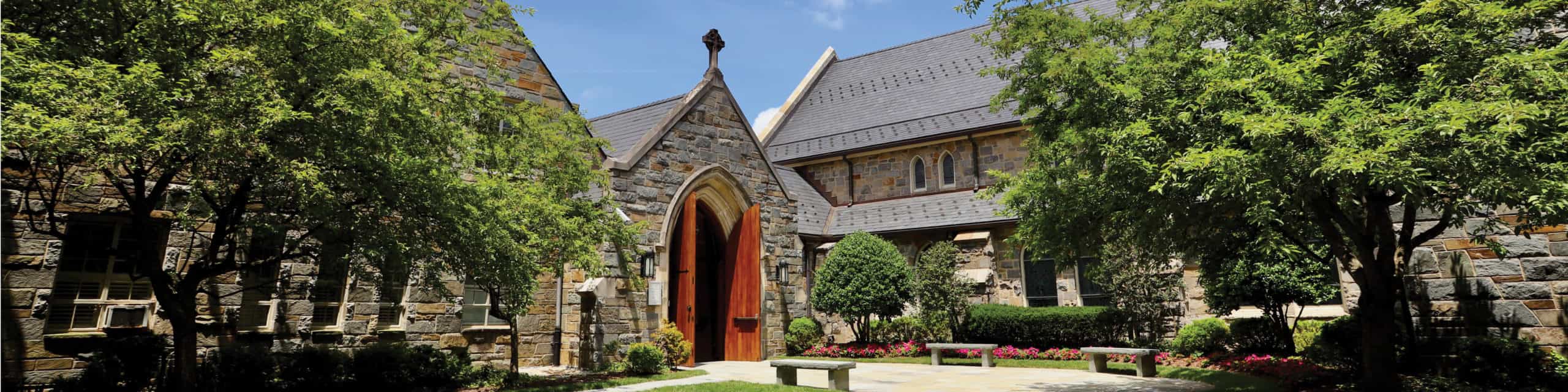 Church entrance with landscaping and a welcoming door